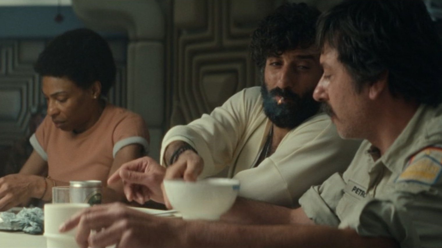 The crew of the doomed ship chat at the table.