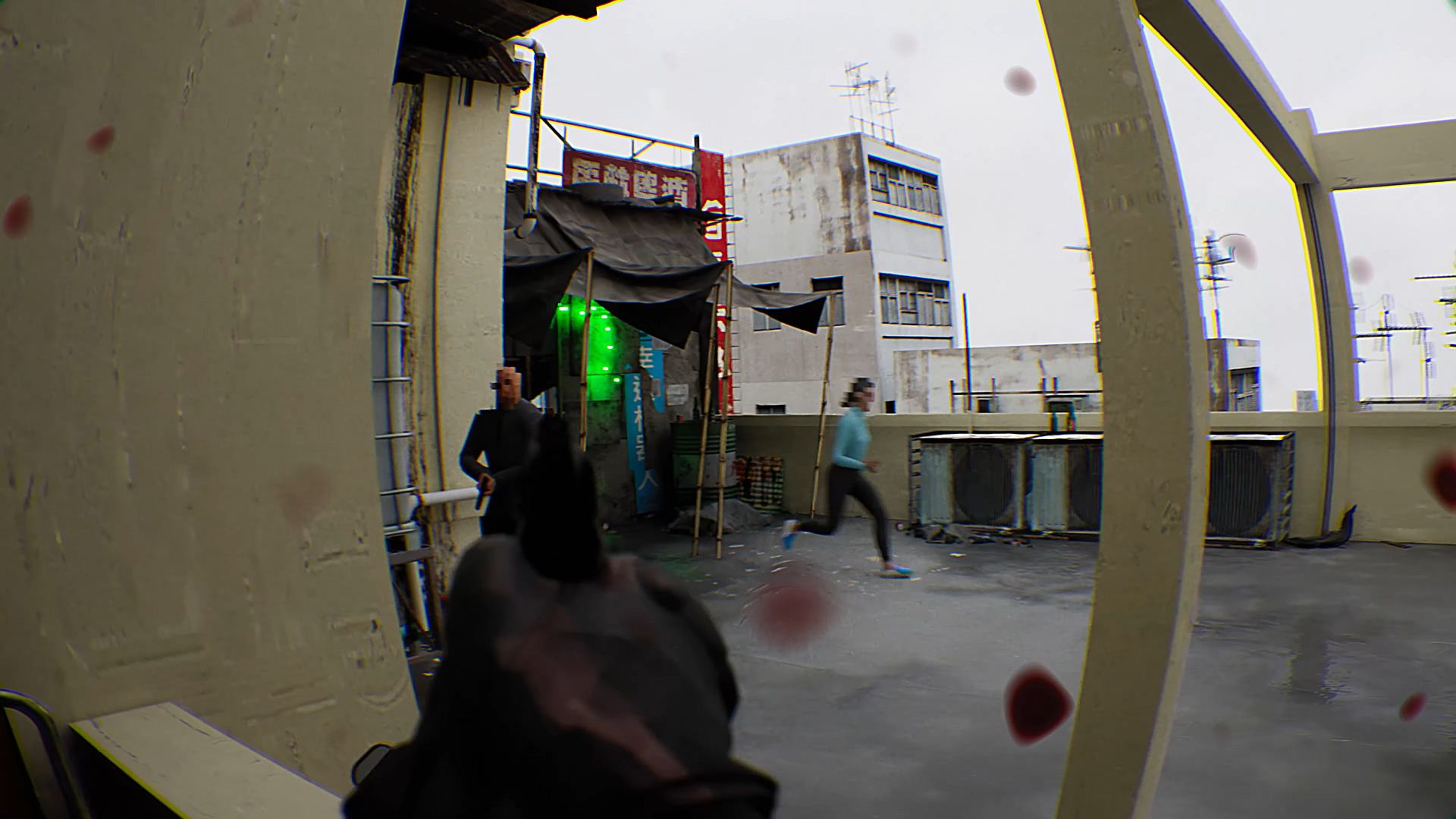 A gun aimed at people on the roof of a building.